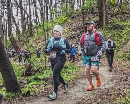 Runners on a wooded trail during a race.