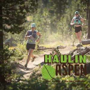 Two female runners on a wooded trail during the Haulin' Aspen Half Marathon.