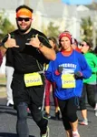 Two runners, one man and one woman, participating in a race.
