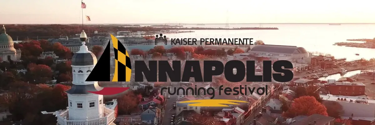 Aerial view of Annapolis, Maryland, with the State House dome and waterfront, featuring the Annapolis Running Festival logo and sponsor text.