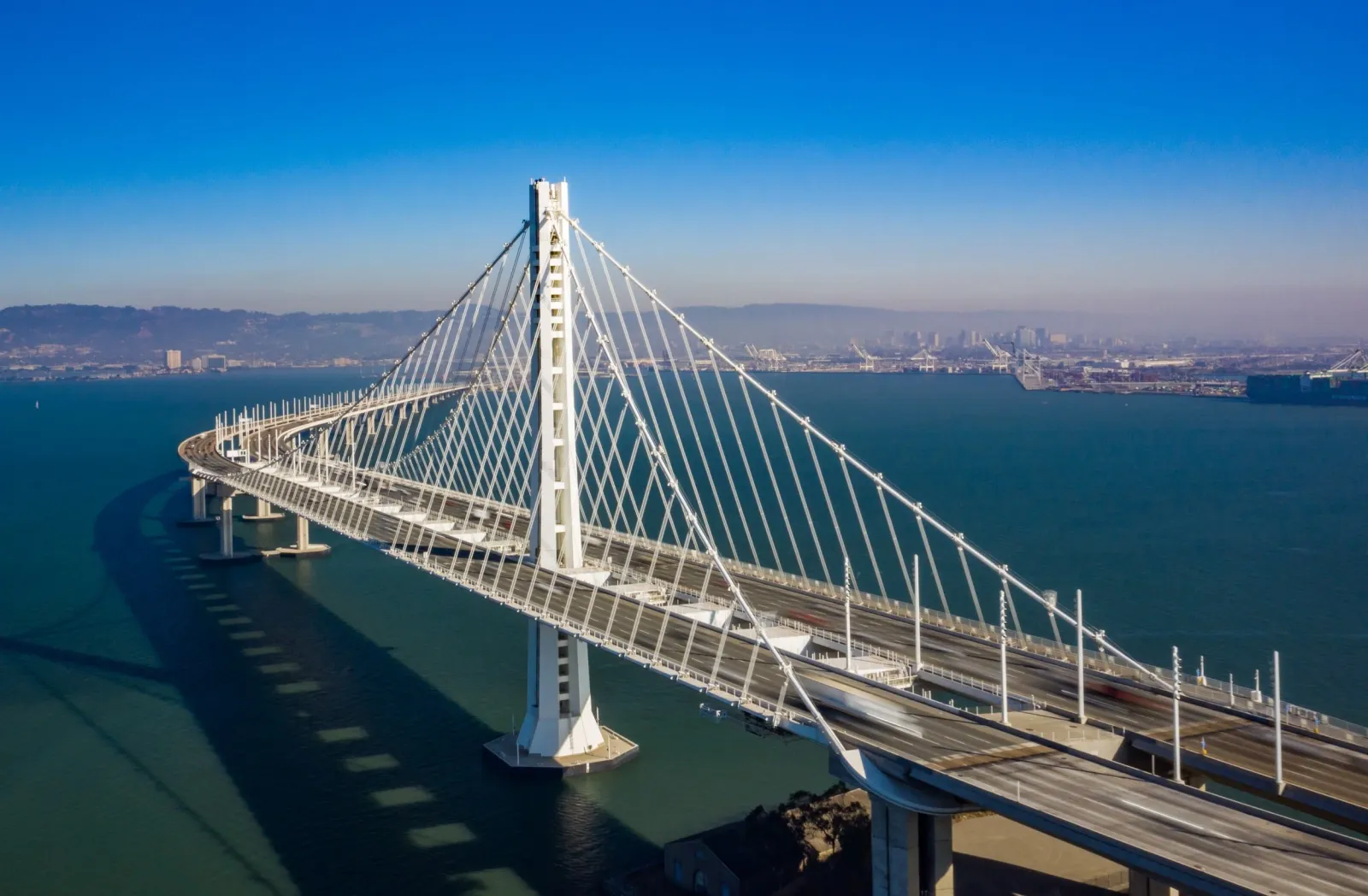 Aerial view of the Bay Bridge with the San Francisco skyline in the background.