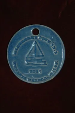 Blue ceramic medallion for the Blueberry Cove 13.5 Half Marathon in Tenants Harbor, Maine, dated 2011.