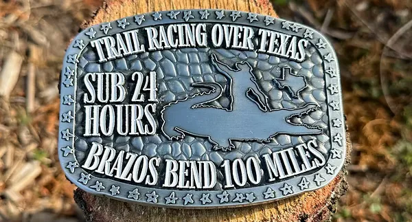 Brazos Bend 100 Miles race buckle with alligator and Texas outline.