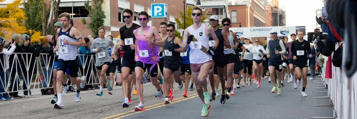 Runners starting the Cambridge Half Marathon, with spectators cheering from the sidelines.