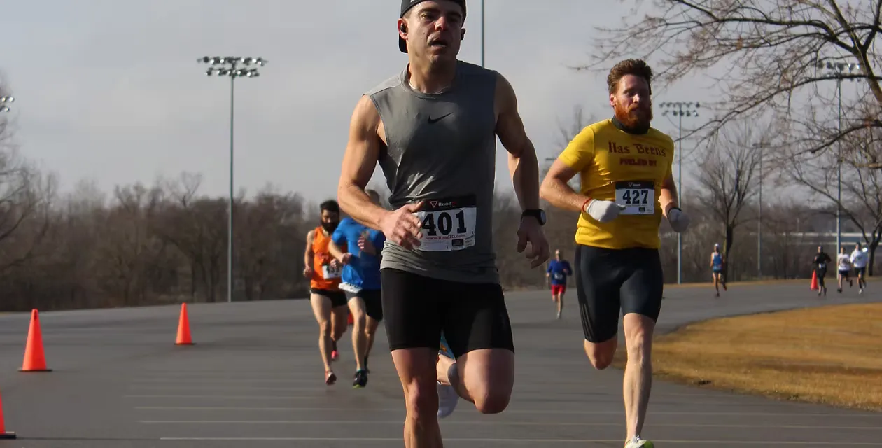 Runners in a race, with bib numbers visible.