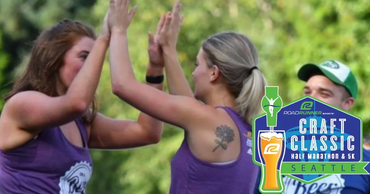 Two women giving each other a high five with a man in the background, and race branding overlayed.