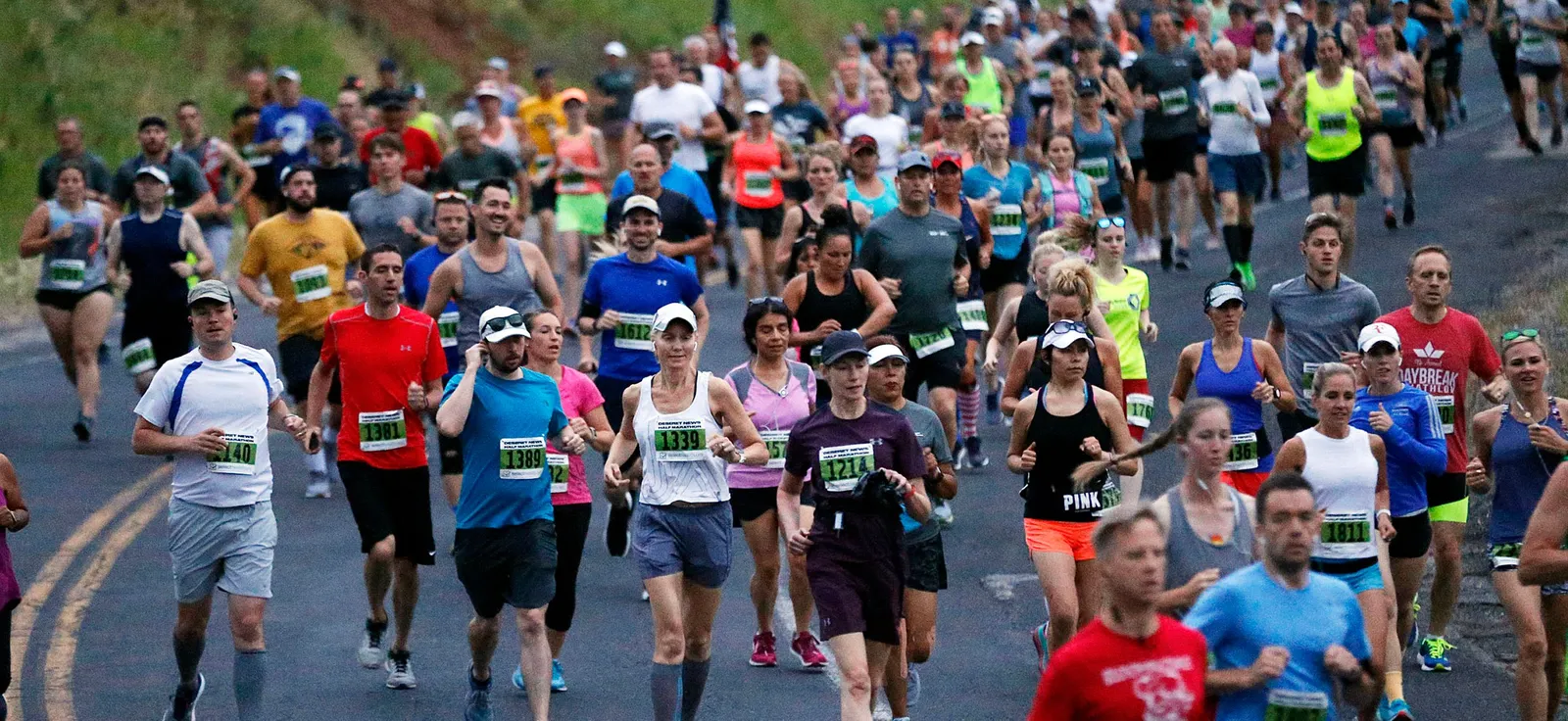 A large group of runners participating in the Deseret News Classic Half Marathon, with many runners in focus and some in the background.