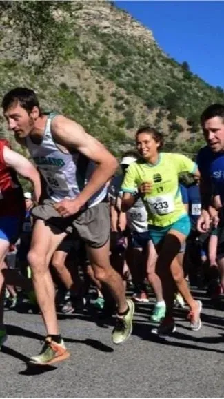 Runners in a race, with a mountain in the background.