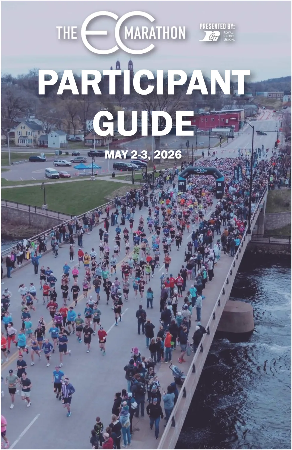 A large group of runners crossing a bridge during the Eau Claire Marathon, with the words 'Participant Guide' and the race date prominently displayed.