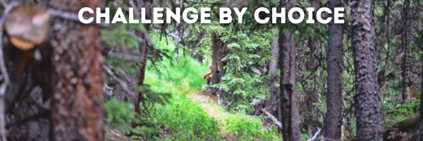 A runner on a trail in a forest with the text "CHALLENGE BY CHOICE" overlayed.