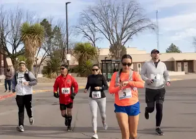 Runners participating in a race, with several individuals in the foreground running towards the camera.