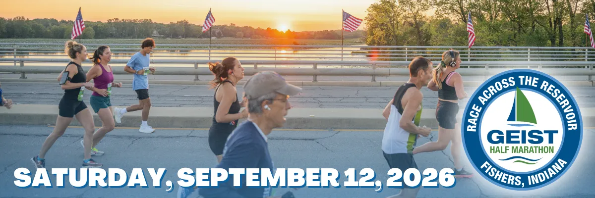 Runners race across a bridge at sunset with American flags and the Geist Half Marathon logo.
