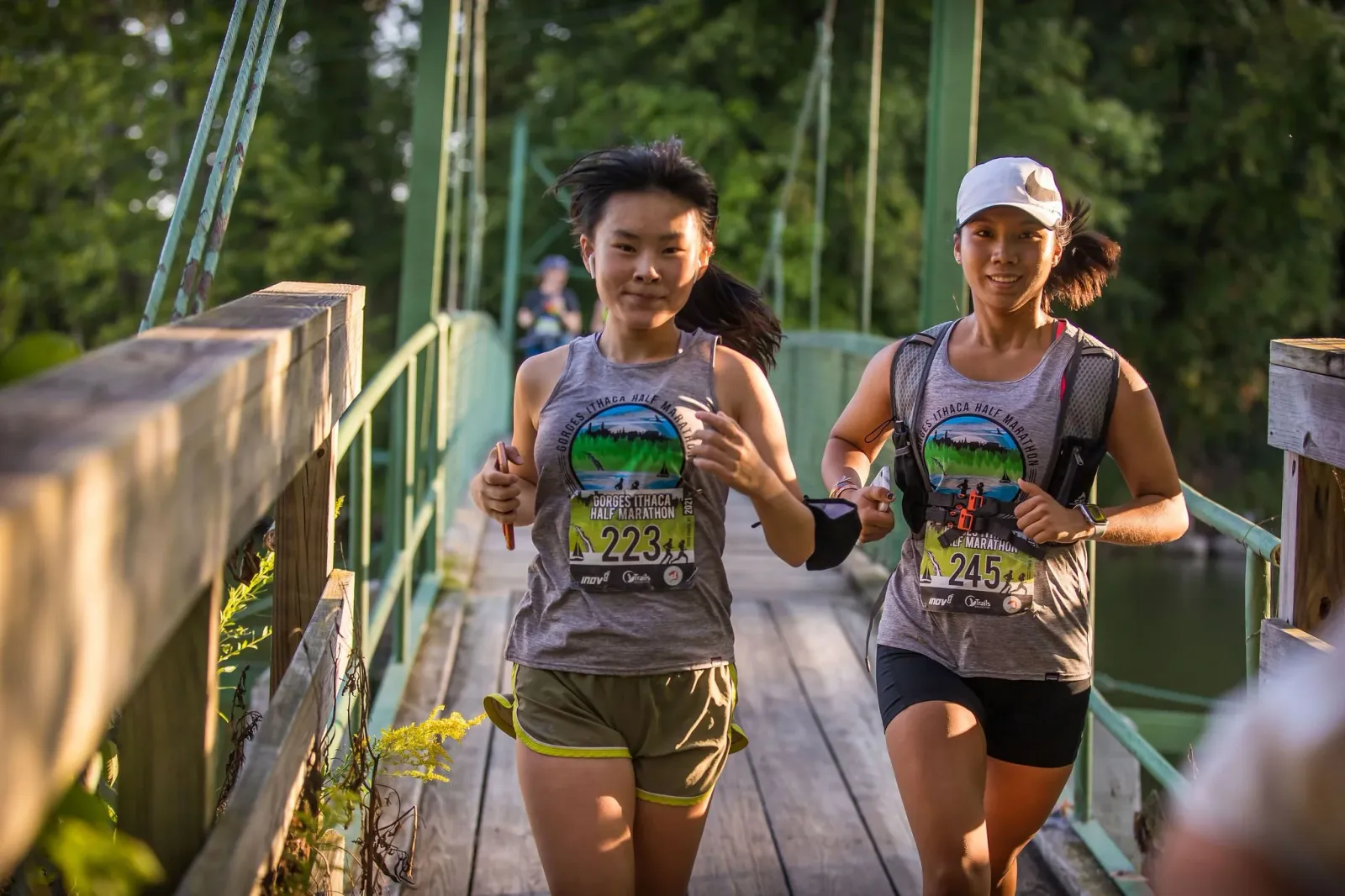 Two female runners on a bridge during the Gorges Ithaca Half Marathon.