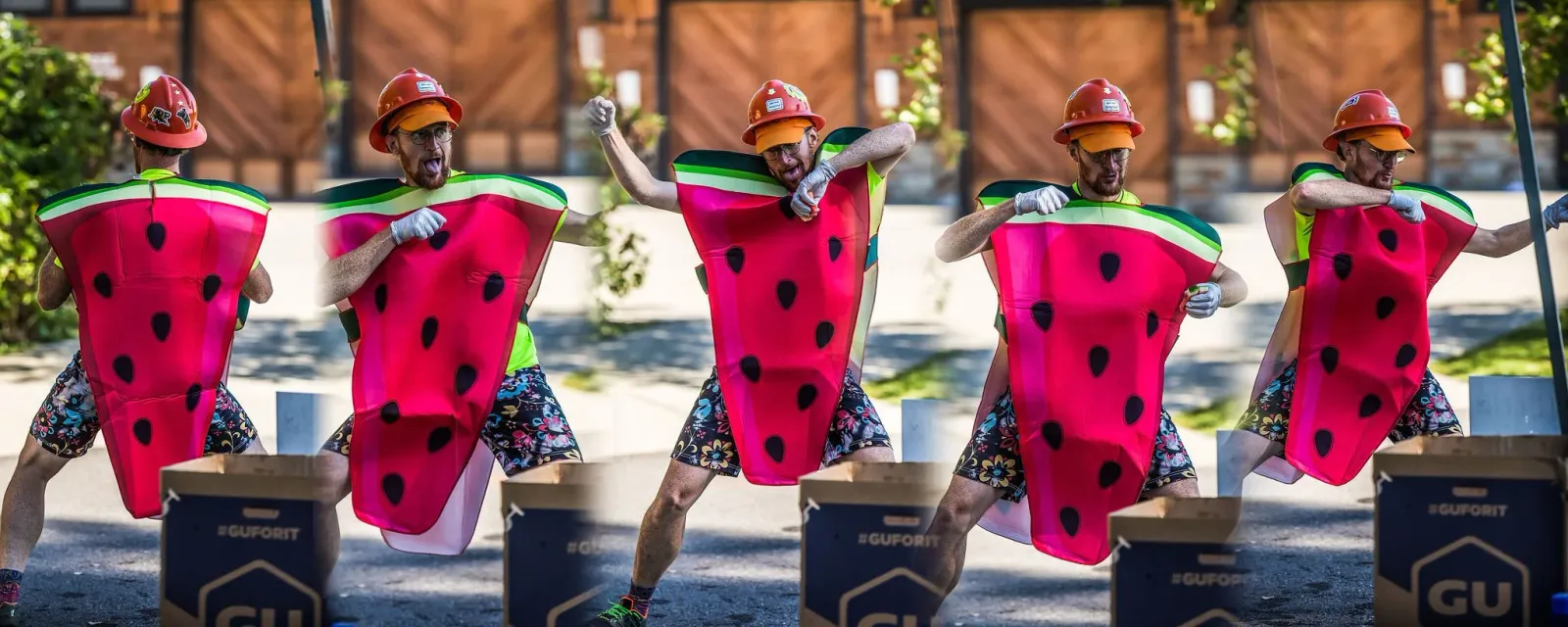 Runners in watermelon costumes celebrating at a race.