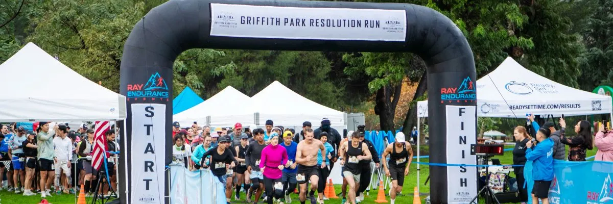 Runners gathered at the start line under an inflatable archway for the Griffith Park Resolution Run.