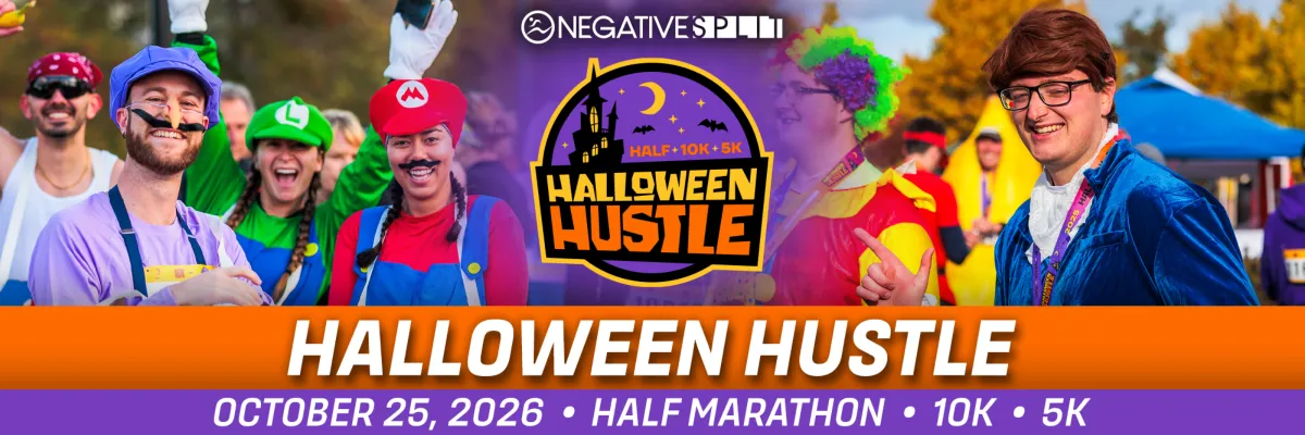 Runners in Halloween costumes, including Mario and Luigi characters, smiling and celebrating at the start of the Halloween Hustle race.
