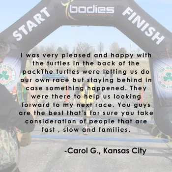 Start and finish line archway with a testimonial overlay from Carol G. about the race experience.