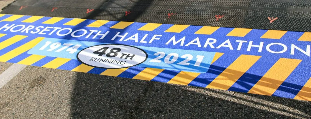 The start/finish line for the Horsetooth Half Marathon, showing the year 1974 and '48th Running 2021'.