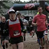 Runners starting a race under an inflatable arch.