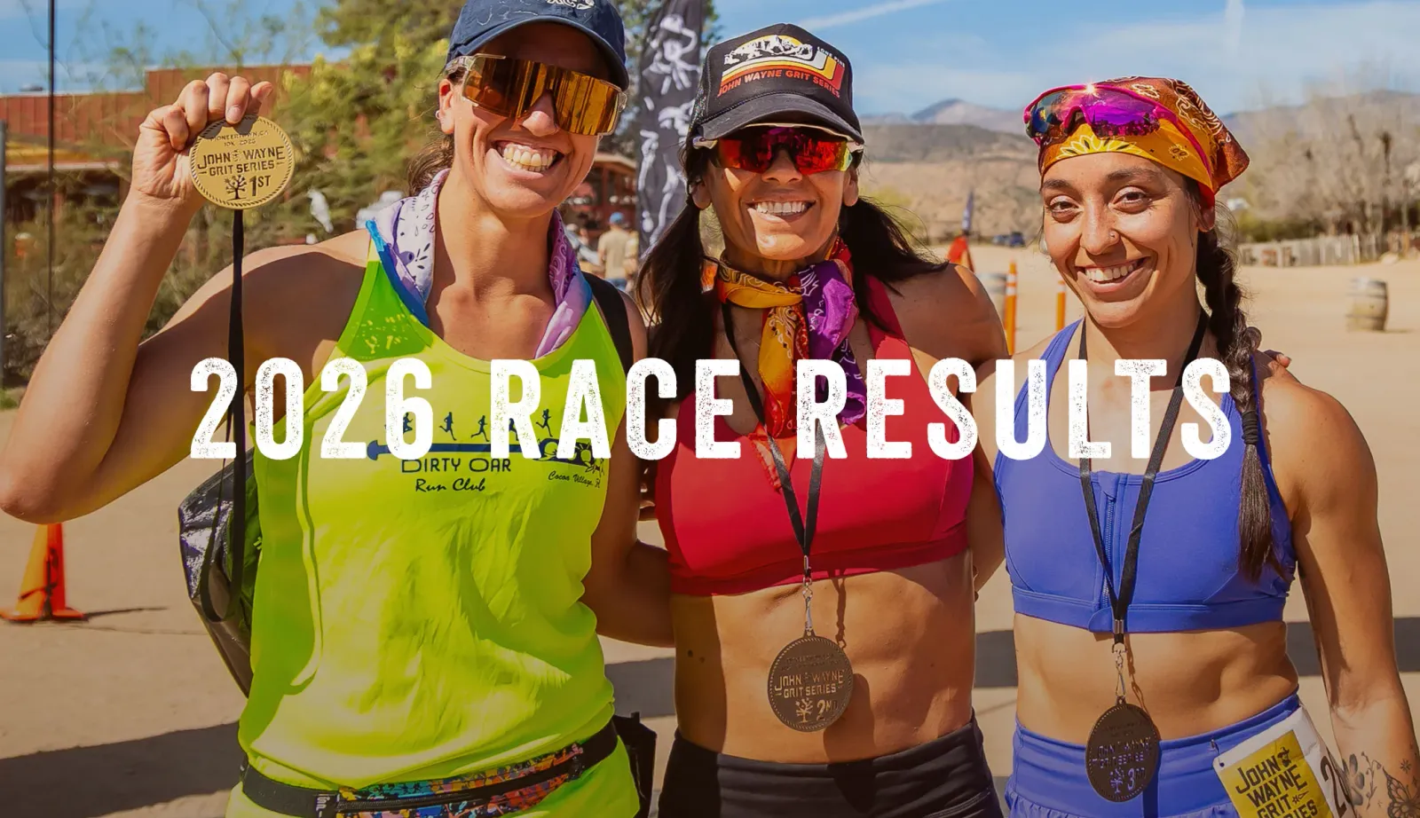 Three smiling women wearing race medals and athletic wear, with large text overlay reading '2026 RACE RESULTS'.