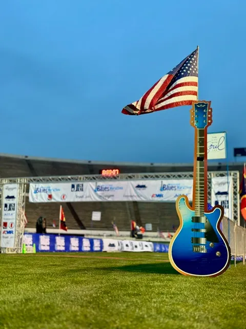 Start/finish line of the Mississippi Blues Marathon with an American flag and a guitar graphic.