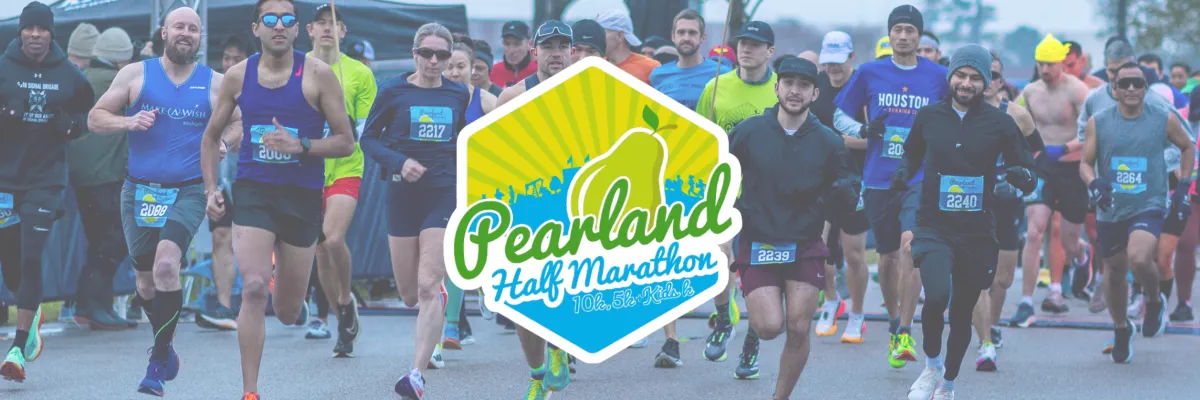 A group of runners starting the Pearland Half Marathon, with the race logo prominently displayed.