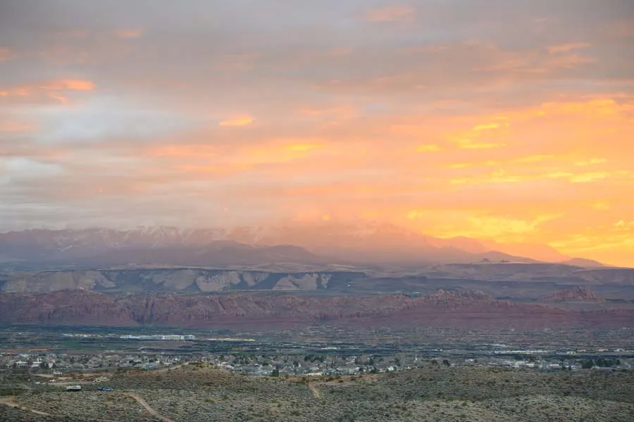 Scenic view of mountains and a town at sunrise, likely part of the Red Mountain race course.