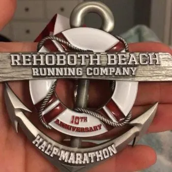 Rehoboth Beach Running Company 10th Anniversary Half Marathon medal featuring an anchor and life preserver design.