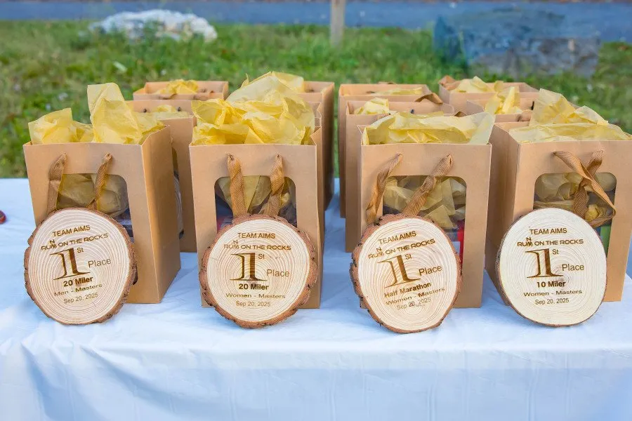 Race medals and prize bags displayed on a table.