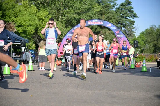 Runners starting a race under an archway with the 'Runapalooza' logo.