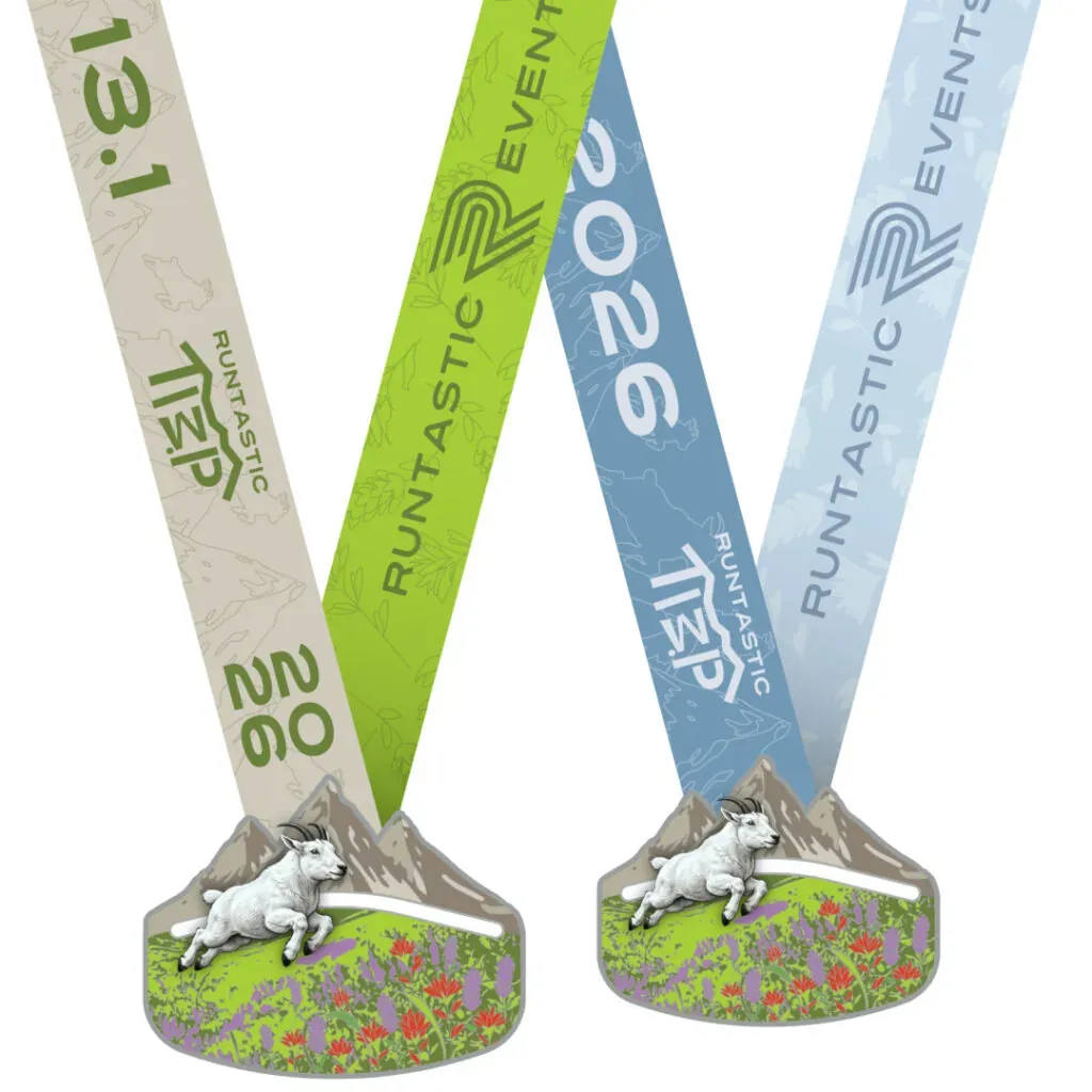 Two finisher medals for the Runtastic Timp race, featuring mountain goats, wildflowers, and race branding.