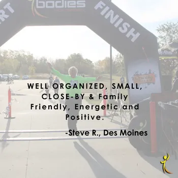 A runner with arms outstretched celebrates crossing the finish line at the Spooky Sprint Columbus race, with a quote overlay.
