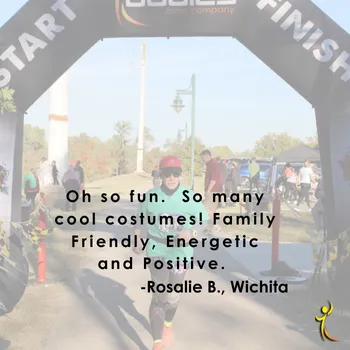 Runner in a green shirt and red hat crossing the finish line under an archway, with a quote overlay about the race being fun and family-friendly.