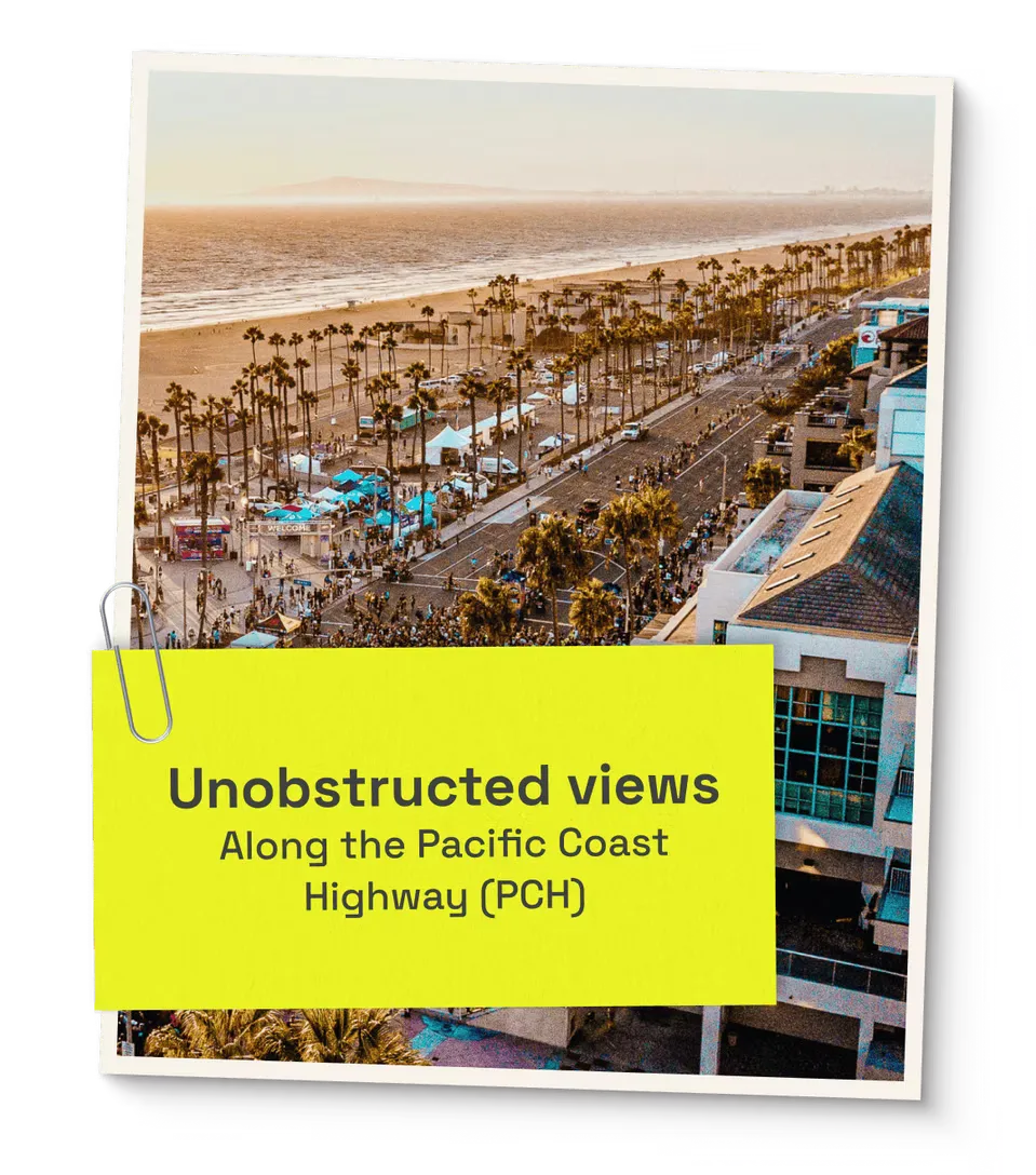Scenic view of the Surf City 10 Mile race course along the Pacific Coast Highway with palm trees and the ocean.