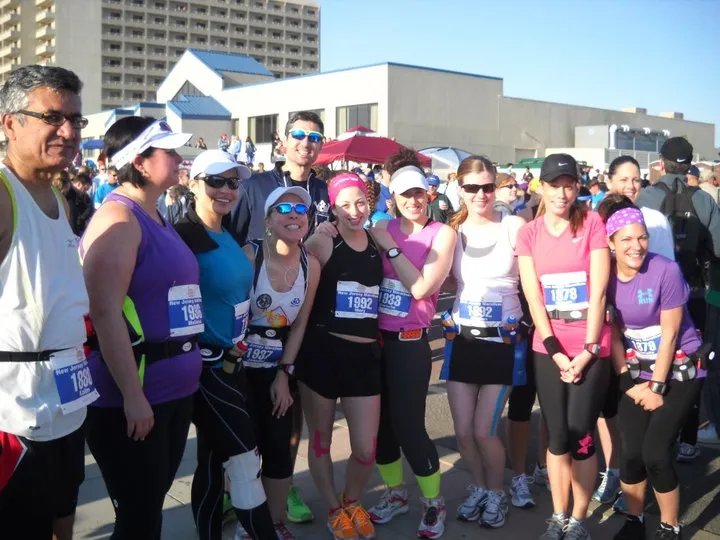 A group of runners, mostly women, pose for a photo before the start of the Bay Ridge Half Marathon.