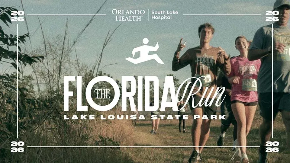 Runners participating in The Florida Run at Lake Louisa State Park, with some smiling and giving peace signs.