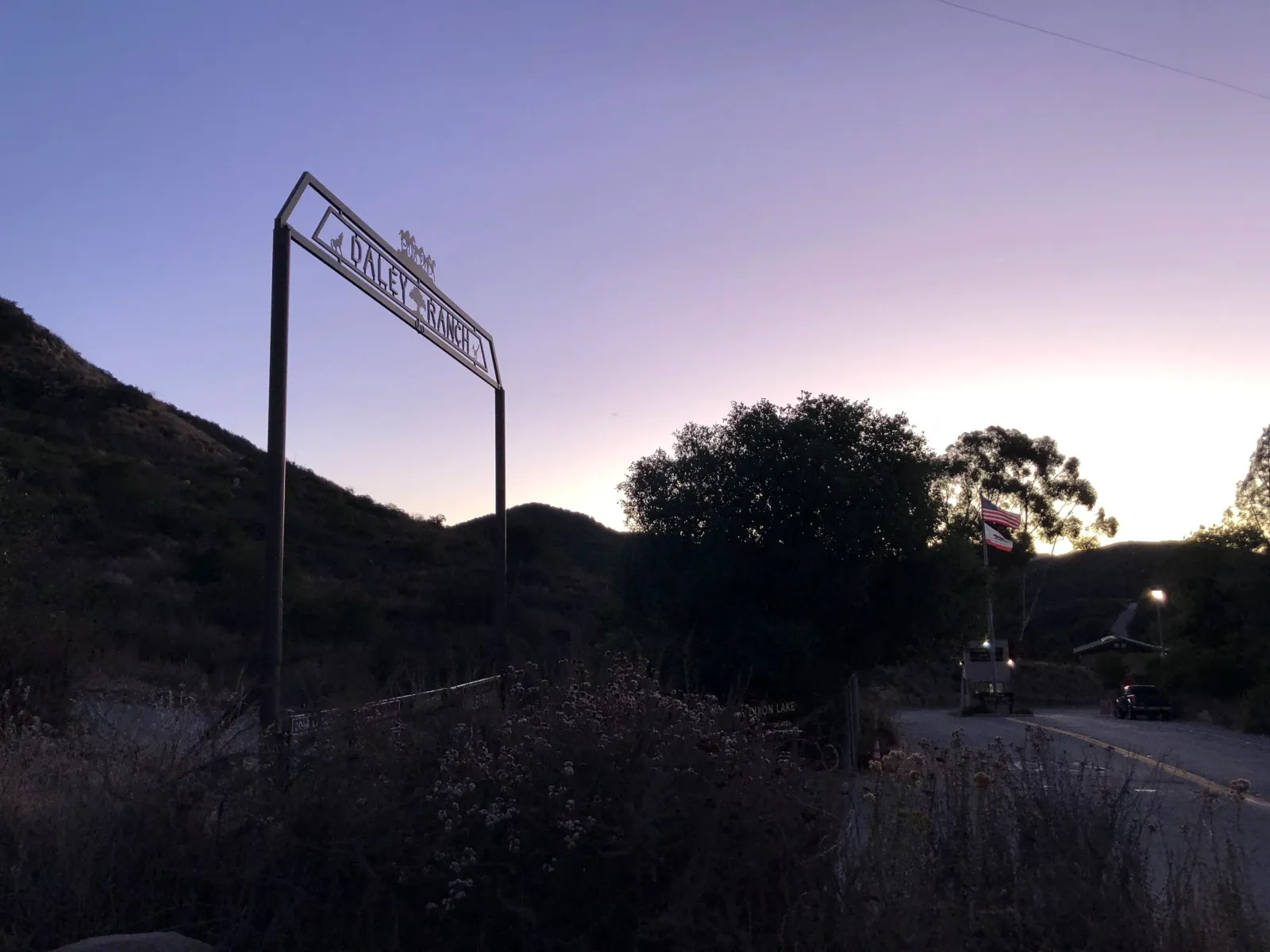 Entrance sign for Daley Ranch at dusk with a purple and pink sky.