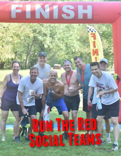 A group of runners smile and pose for a photo under a red finish line archway, with the text 'RUN THE RED SOCIAL TEAMS' overlaid in large red letters.