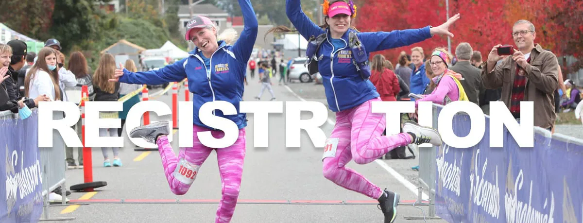 Two women in pink leggings and blue jackets jump in the air with excitement at a race start or finish line, with the word "REGISTRATION" overlaid on the image.