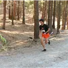 A runner on a wooded trail.