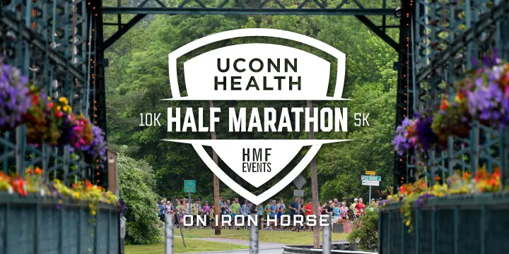 Runners gathered at the start line of the UCONN Health Half Marathon, framed by decorative gates and hanging flowers.