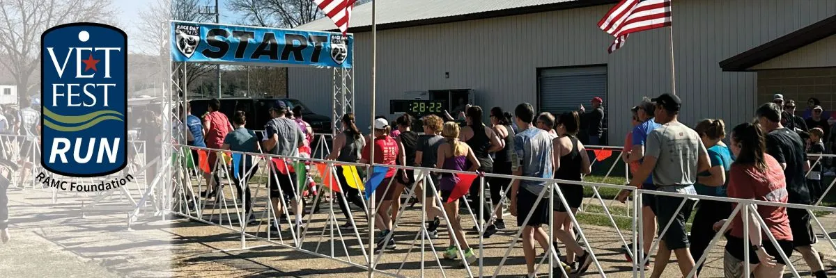 Runners gather at the start line under a banner that reads 'START' for the Vet Fest Run.