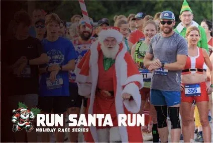 Runners in festive holiday costumes, including Santa Claus, an elf, and others, gather at the start line of the Run Santa Run Holiday Race Series.