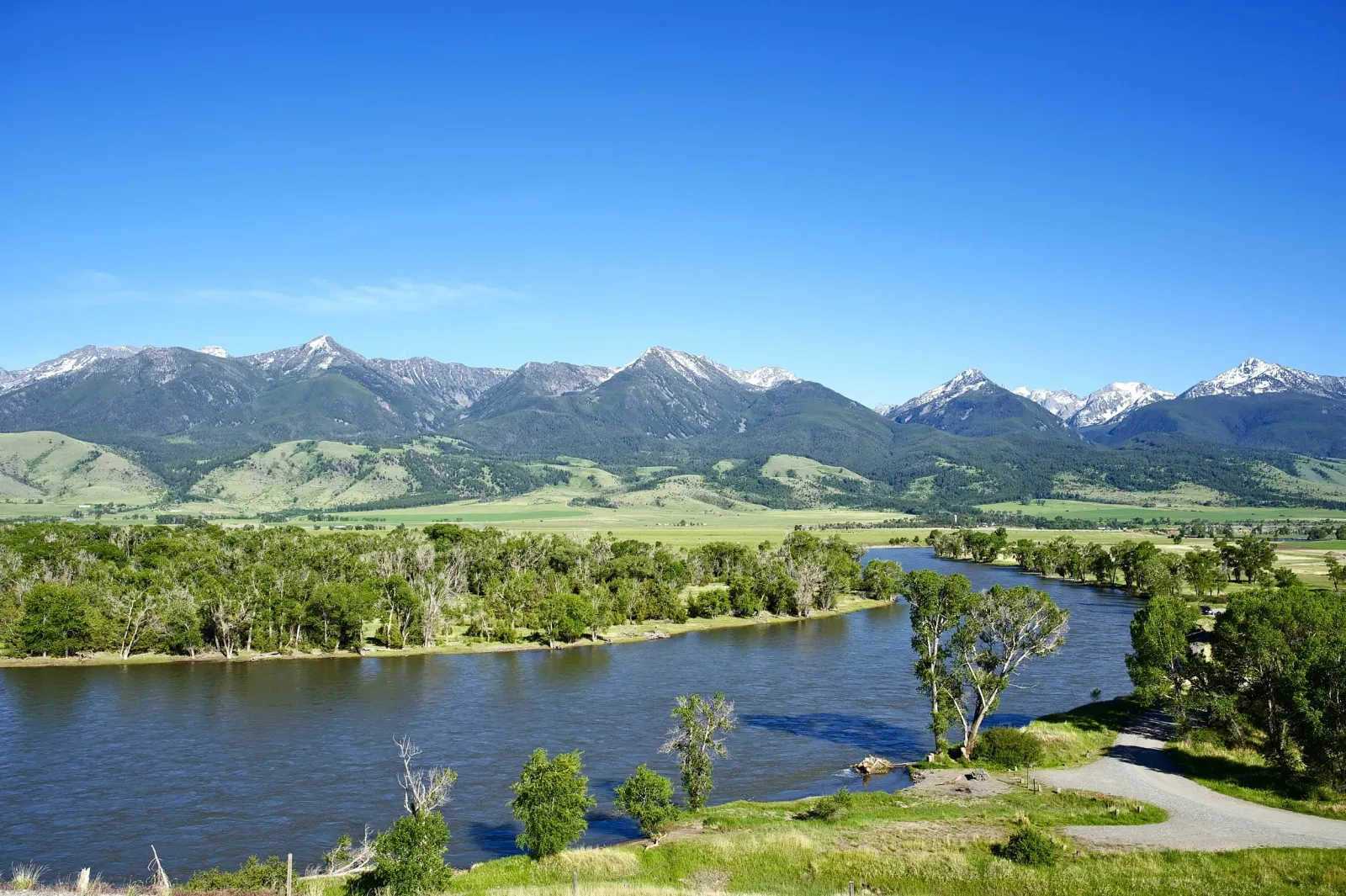 Scenic view of a river with mountains in the background.