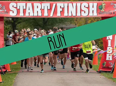 Runners crossing the start/finish line at a race, with a green banner across the image that says 'RUN'.